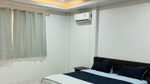A bedroom with a bed, a window with curtains, an air conditioning unit, and a tiled floor. - The Green Horizon Villa Chaweng Hill (Koh Samui)