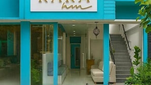 A building with a turquoise facade and a sign that reads "RARA". - Rara HM (Hulhumale)