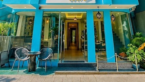 A blue building with the name "RARA" on the facade, featuring a modern design with multiple windows and a visible entrance. - Rara HM (Hulhumale)