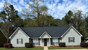 A two-story house with a front porch, a driveway, and a lawn. - centrally located 3 bed 2 bath (Albany)