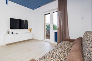 Design Apartment, Balcony, City View | Living area | 50-inch flat-screen TV with digital channels - Blue Holiday (Meta)