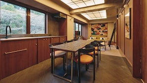 A modern kitchen with a large island, wooden cabinets, and a view of trees outside. - illi Toas Tokyo-Toranomon (Tokyo)