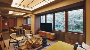 A hotel room with a large window, a television, a bed, a dining table, and a seating area. - illi Toas Tokyo-Toranomon (Tokyo)