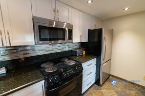 Fridge, microwave, oven, stovetop - Slopeside Penthouse Apartment with Pool, Hot Tub and Sauna (Whistler)