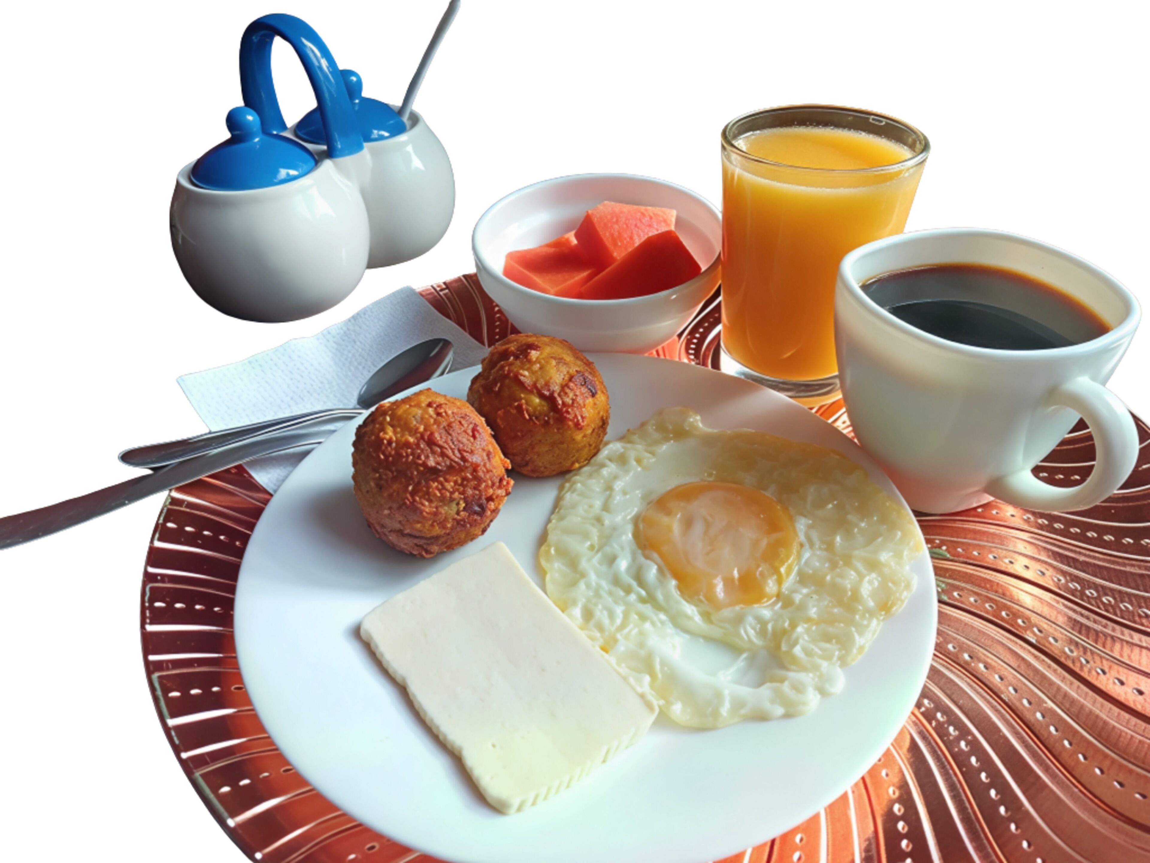 A breakfast plate with eggs, sausage, cheese, and a glass of orange juice.