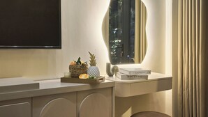 A modern bathroom with a vanity, a mirror, and a window with curtains. - Secret Garden Phan Xich Long (Ho Chi Minh City)
