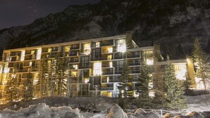 A multi-story hotel with balconies, surrounded by trees and a mountainous backdrop. - Ski-in/ski-out unit for 4 people @Snowbird for New Year's week, 12/27-1/3 (Snowbird)