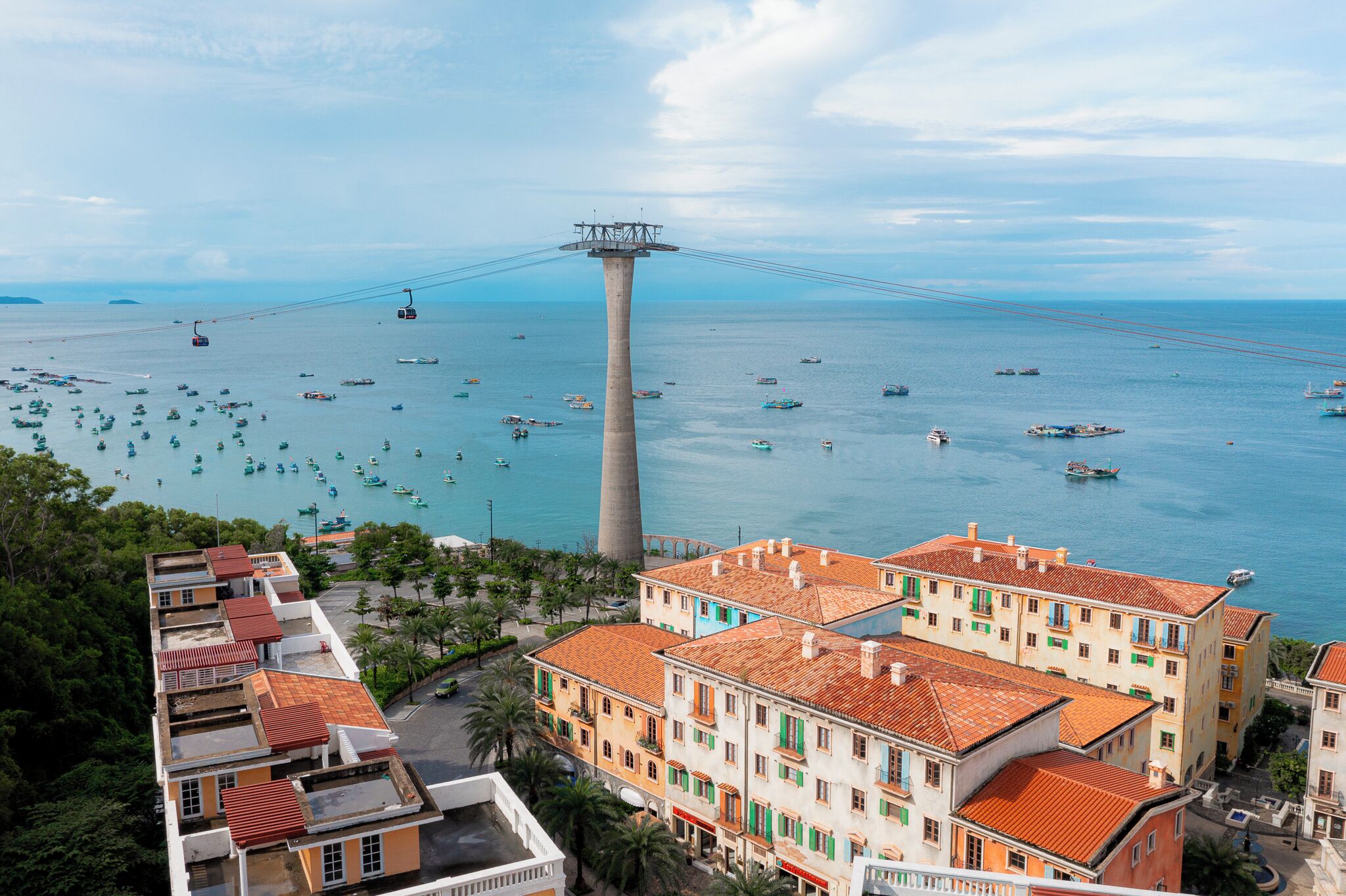 A coastal cityscape with a prominent tower, boats, and colorful buildings.