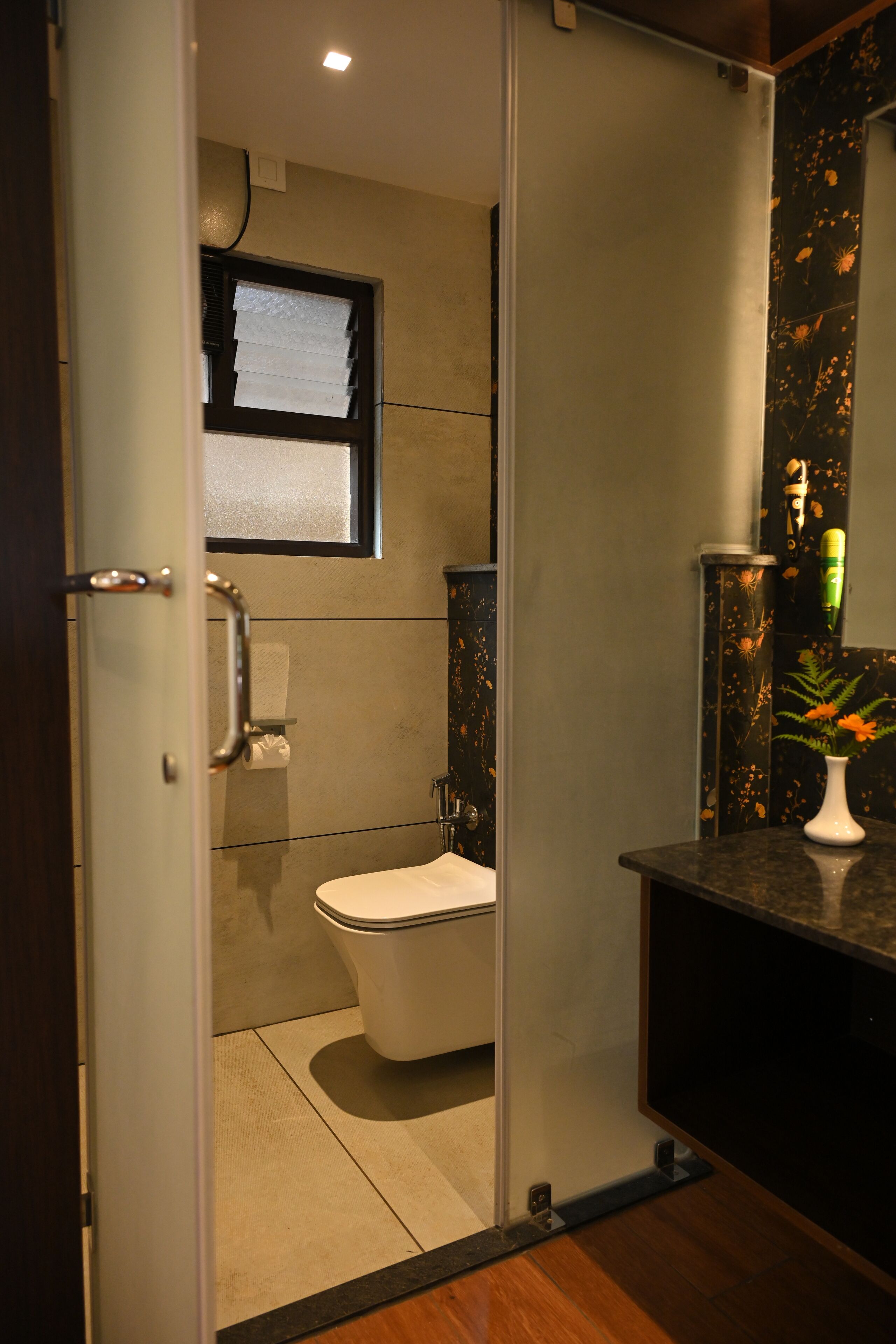 A modern bathroom with a toilet, a sink, and a mirror.