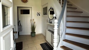 A staircase with white balusters and wooden steps leading to an upper floor.