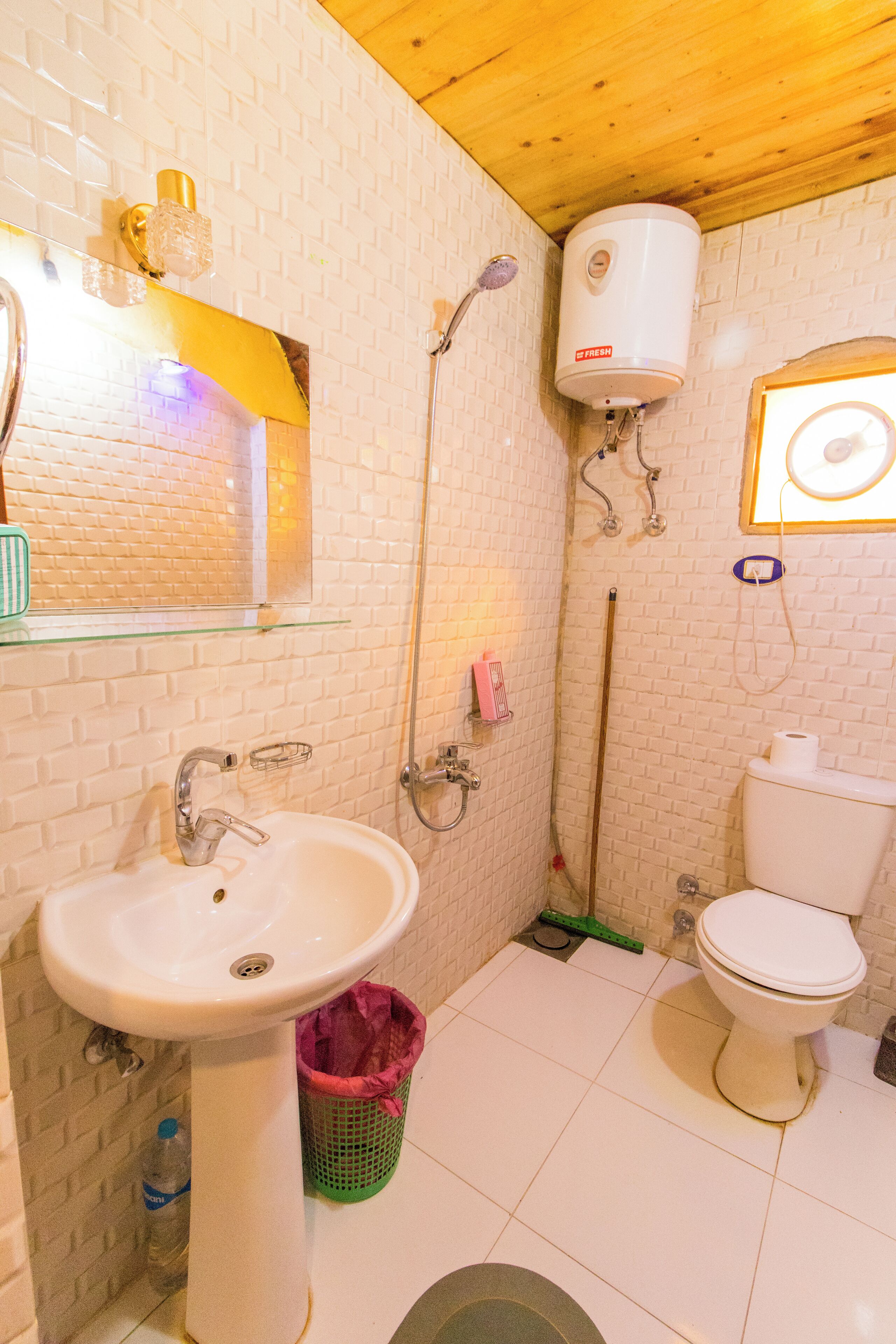 A bathroom with a white sink, toilet, and shower.