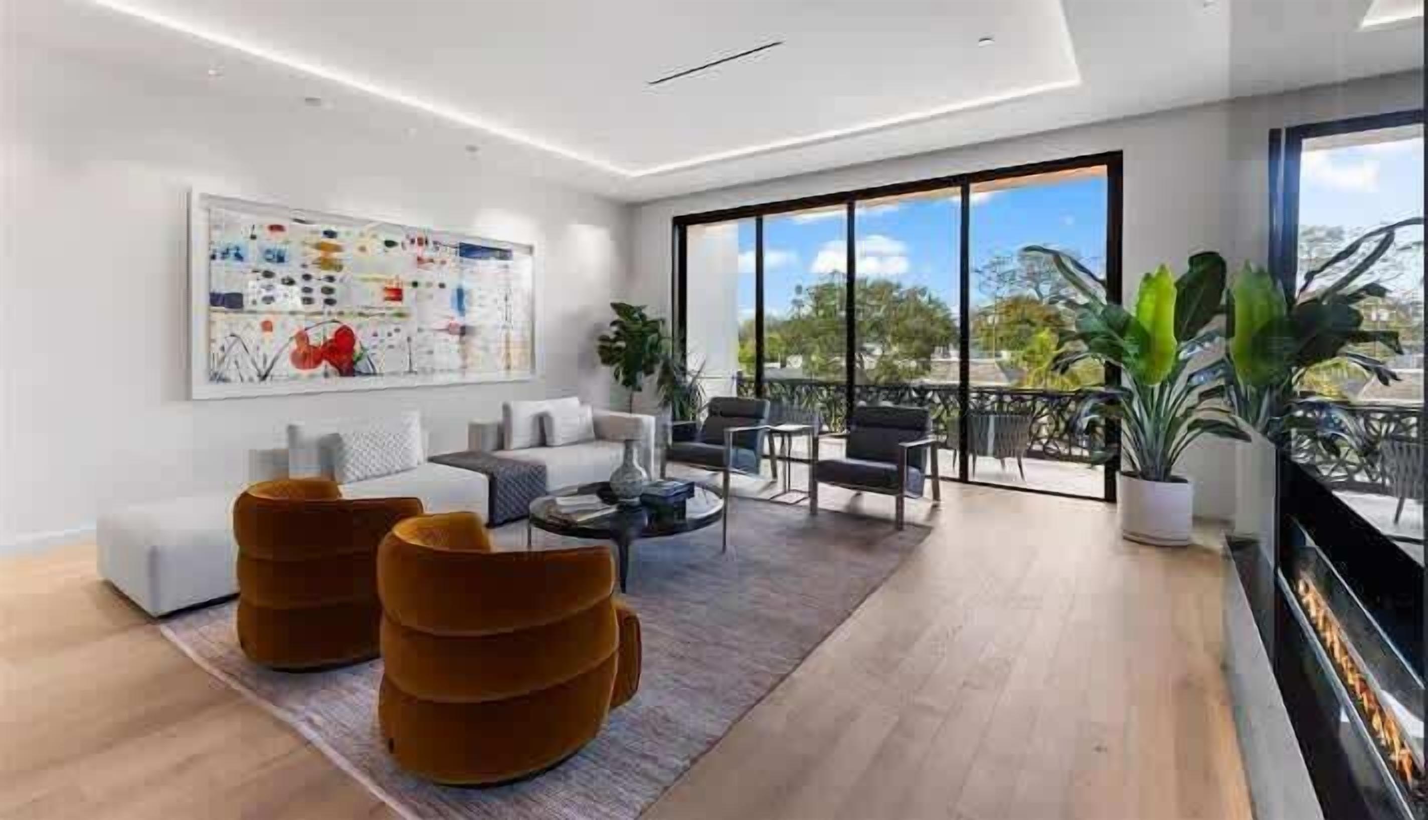 Un salon moderne avec un canapé, une table basse et des fauteuils. Une grande fenêtre offre une vue sur l’extérieur.