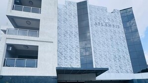 A modern building with a patterned facade and a flat roof. - ATLANTIS HOTELS (Lagos)