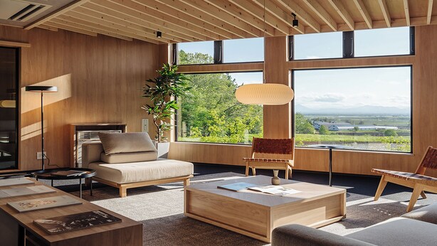 A modern living room with large windows, a sofa, a coffee table, and a fireplace. - LANSHAN HOTEL  (Naganuma)