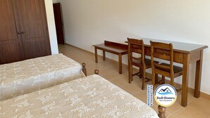 A bedroom with two beds, a wooden desk, and a chair. - ID #14 BnB Homes Villa (Albufeira)
