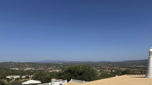 A coastal view with a white lighthouse, terraced buildings, and a clear sky. - ID #14 BnB Homes Villa (Albufeira)