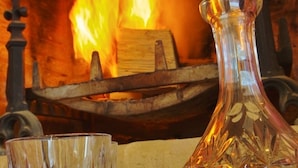 A fireplace with a glass vase and a glass. - North Cottage at Boath Stables – A Cozy Highland Escape (Nairn)