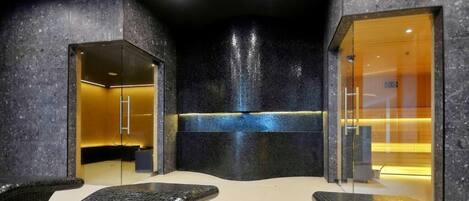 A modern spa area with a reception desk, seating area, and a glass-enclosed shower.
