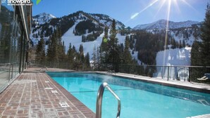 A pool with a metal ladder, surrounded by glass walls, with a mountain view. - Ski-in/ski-out unit 1027 for 4 people @Snowbird for New Year's week, 12/27-1/3 (Snowbird)