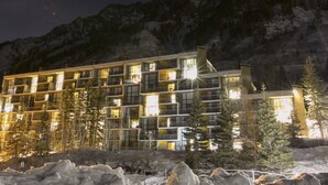 A multi-story hotel with balconies, surrounded by trees and a mountainous backdrop. - Ski-in/ski-out unit 1027 for 4 people @Snowbird for New Year's week, 12/27-1/3 (Snowbird)