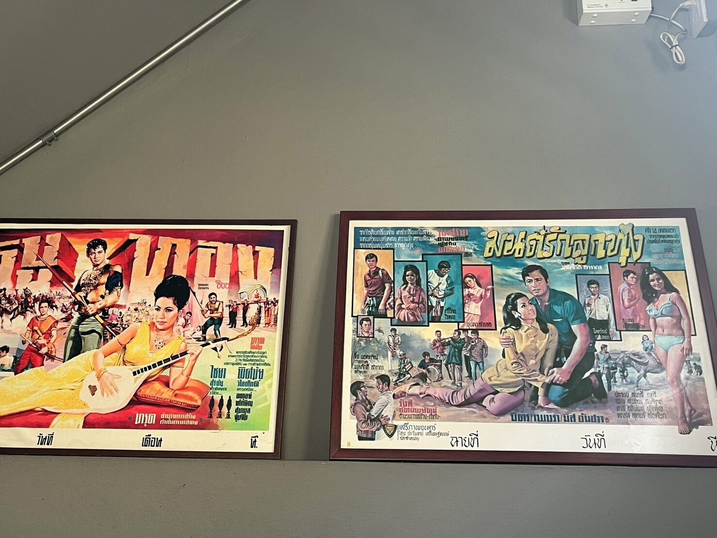 Two framed movie posters on a wall.