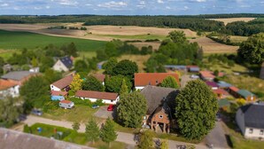 A rural village with traditional houses, a central square, and surrounding fields. - Vacation apartment Cantnitz, your retreat in the middle of the Feldberg lake district. (Feldberger Seenlandschaft)