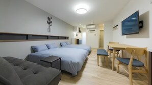 A modern hotel room with a large bed, a sofa, a desk, and a TV. - Yukishigure-Taisho (Osaka)