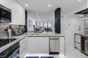 Fridge, microwave, oven, stovetop - Gorgeously Modern Remodeled South Seas Condo on Clam Bay (Marco Island)