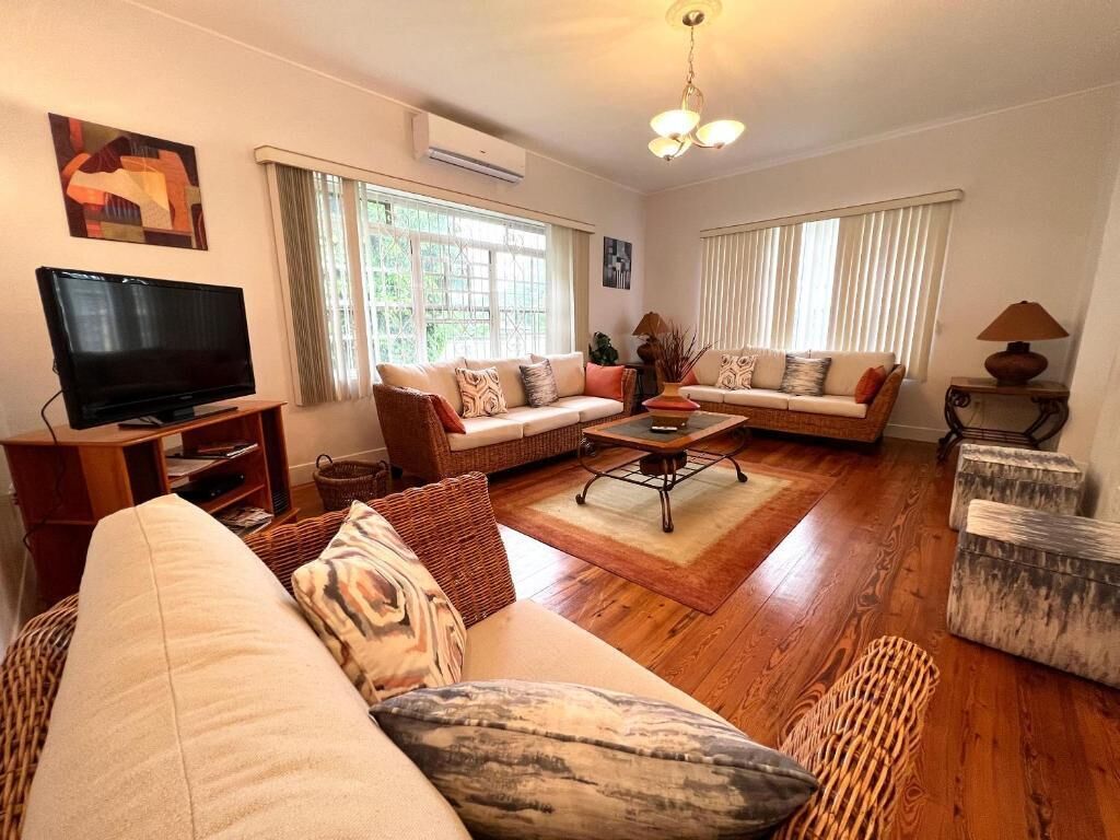 A living room with two sofas, a coffee table, a TV, and a lamp.