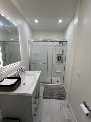 Shower, hair dryer, towels, soap