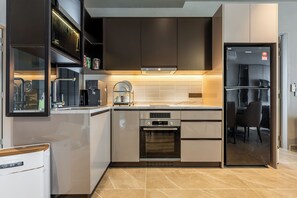 Luxury Suite | Private kitchen | Fridge, cleaning supplies