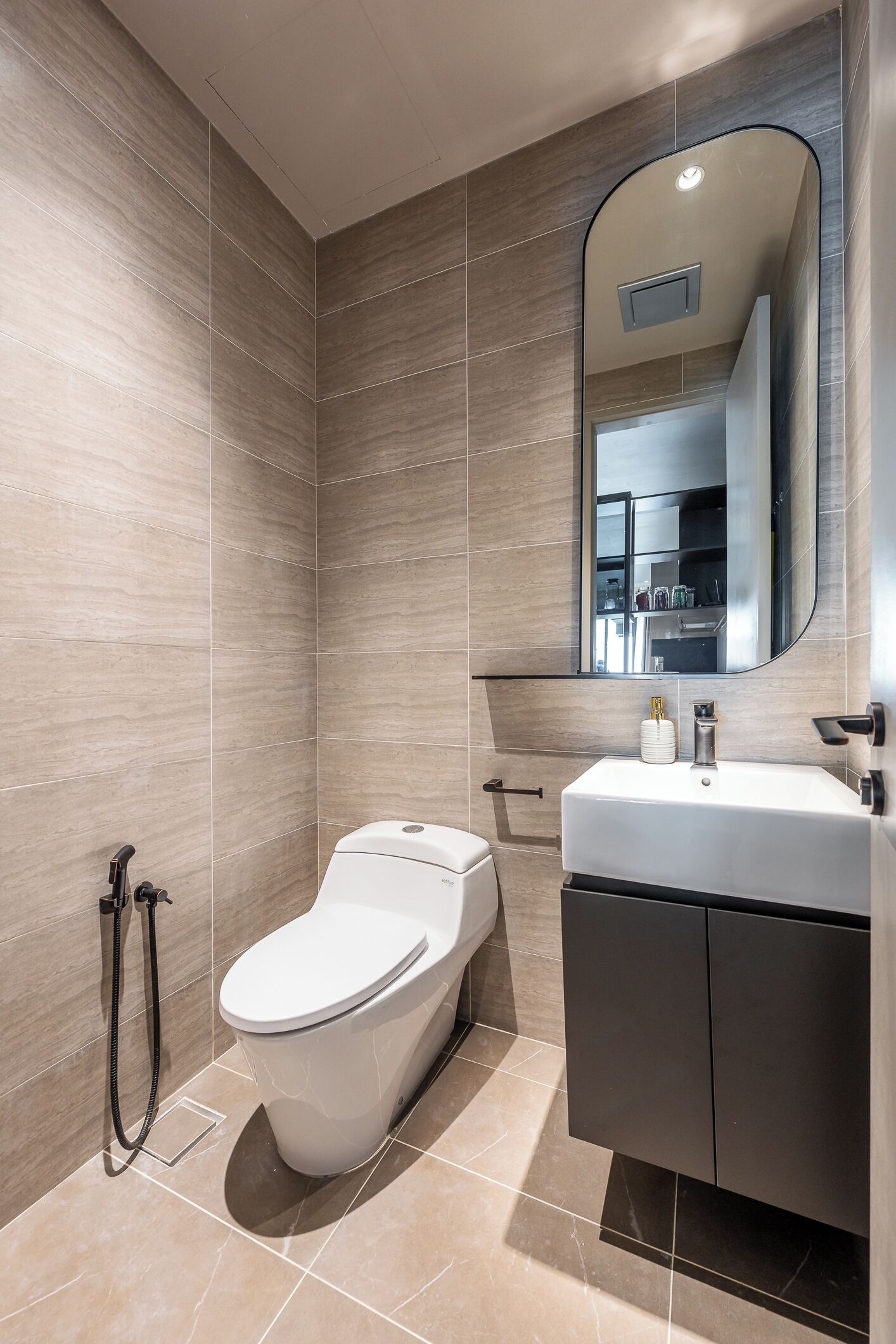 A modern bathroom with a toilet, bidet, and vanity.