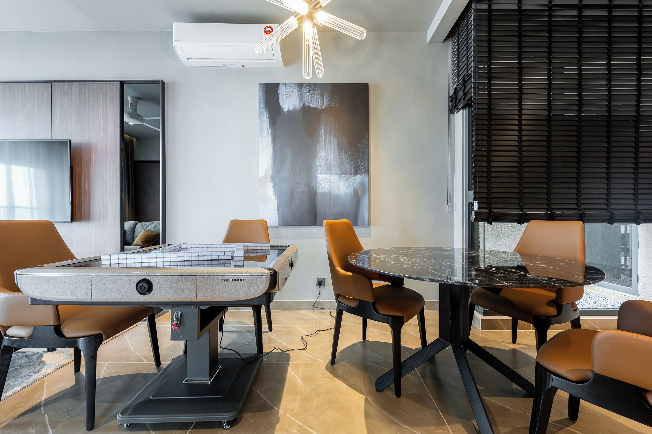 A modern dining area with a pool table, comfortable seating, and a large abstract painting on the wall.