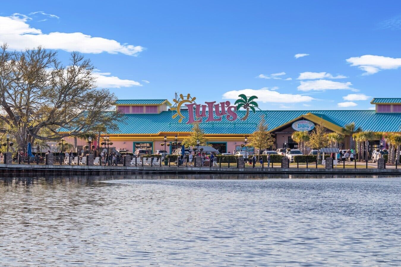 A waterfront restaurant with a colorful exterior and a sign that reads 'LuLu's.'