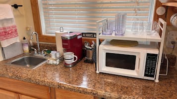 Fridge, microwave, coffee/tea maker, cookware/dishes/utensils