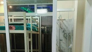 A room with bunk beds and a shower area. - Entire rental unit - bright space and a magnificent overlooking view of area. (San Jose del Monte)