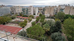 A residential area with multi-story buildings, a playground, and trees. - City Panorama Studio by ΜΡS (Athens)