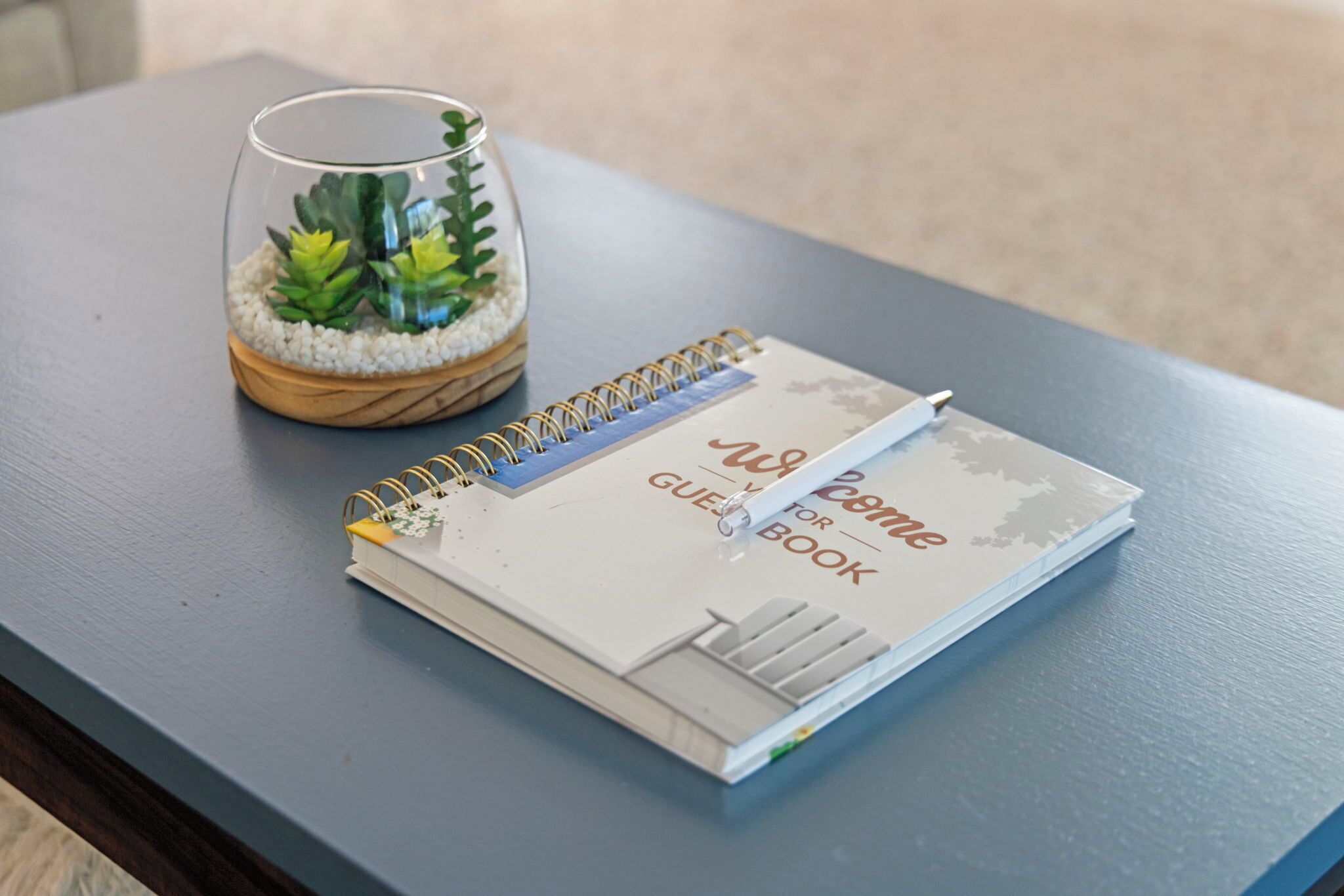 A notebook titled "Welcome Guide for Guests" on a table.