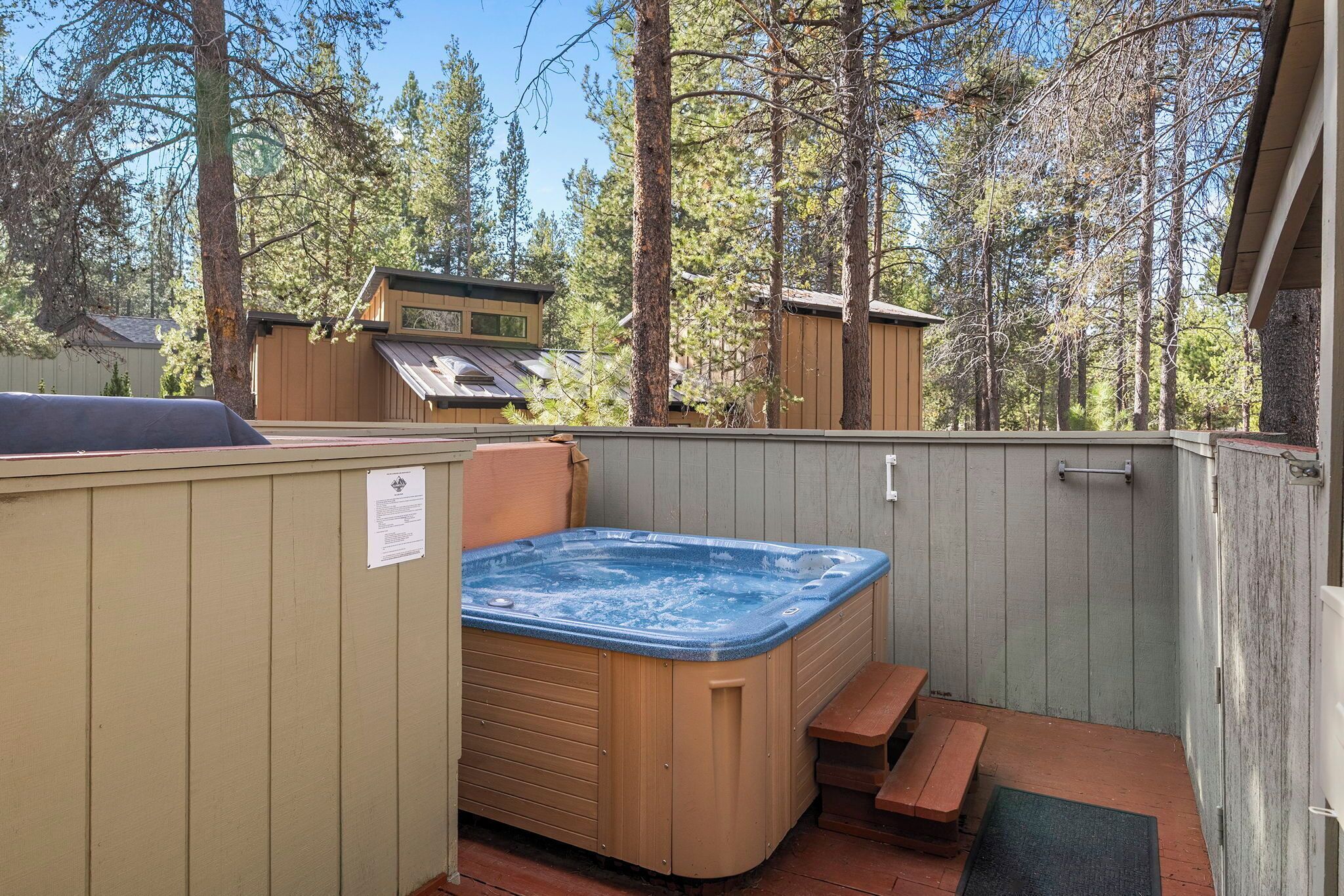 Hot tub on the side deck of the house near the front door. 