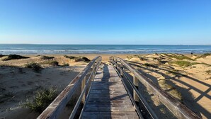 A wooden boardwalk leading to a beach with dunes and ocean views. - Vista Mare House | Private Spa Terrace • Sea View • (Santa Maria del Focallo)