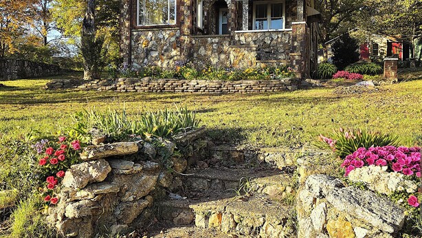 A stone house with a stone facade, a wooden roof, and a front porch. - Historic Carrie Tucker Cottage with view of Spring River in charming Hardy, Ark. (Hardy)