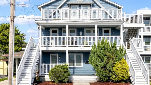 A two-story building with a balcony on each floor, a visible staircase, and a small tree in front. - 2 Blocks to Beach | Downtown OC +  1 Parking Space (Ocean City)