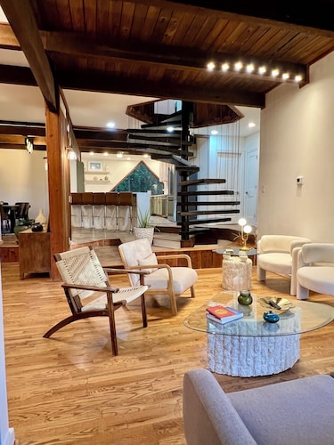  Wood-beam ceilings, large glass windows & a stunning spiral staircase suspended