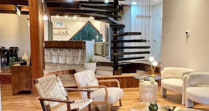 Wood-beam ceilings, large glass windows & a stunning spiral staircase suspended