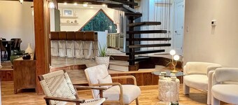 Wood-beam ceilings, large glass windows & a stunning spiral staircase suspended