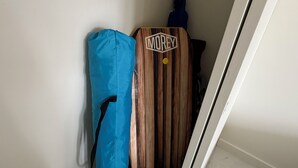 A wooden wardrobe with a 'MOREY' logo, a blue bag, and a dark blue jacket hanging on a white wall. - Ocean View Retreat•4 Mn Walk 2 Beach•Lanai•Sleep 6 @ Waikiki Banyan #908 Tower 1 (Honolulu)
