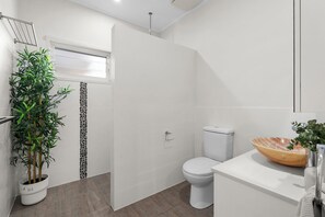 A modern bathroom with a toilet, shower, and sink. - Riverside Retreat with Sweeping Views – Pool, Guest Suite & Entertainers Balcony (Tweed Heads)