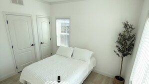 A bedroom with a bed, a potted plant, and a window. - Private and charming Bay Area home. Centrally located to all Bay Area cities! (South San Francisco)