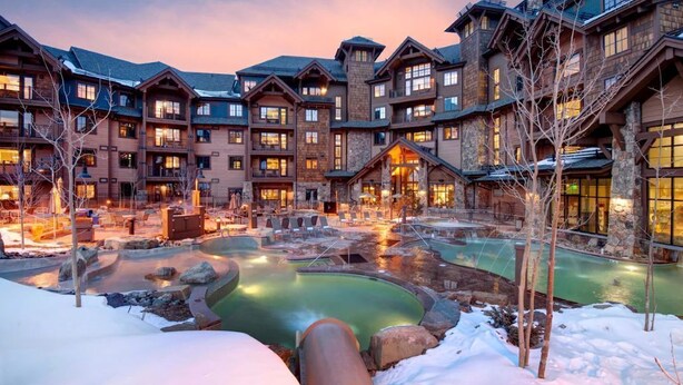 A lodge with multiple buildings, a central pool area, and a snowy landscape. - Ski In/Ski Out Master at Grand Lodge on Peak 7 (Breckenridge)