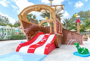 A pirate-themed water play area with a slide and a crocodile-shaped water feature. - Brand-new, modern 3-bedroom townhouse is minutes from Disney World ✨ (Davenport)